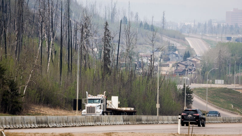 Traffic moves along Alberta Highway 63 as wildfire smoke hangs in air in Fort McMurray, Alta., on Wednesday, May 15, 2024. (Jeff McIntosh / The Canadian Press) 