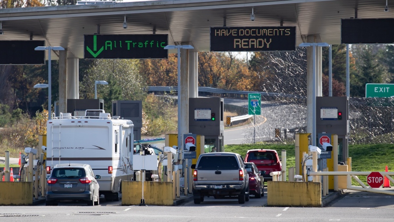 Motorists wait at U.S. Customs and Border Protection inspection booths at the Peace Arch border crossing in Blaine, Wash., across the Canada-U.S. border from Surrey, B.C., on Monday, November 8, 2021. THE CANADIAN PRESS/Darryl Dyck