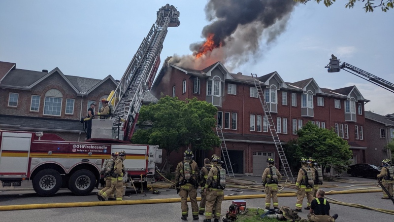 Firefighters battle a fire at a townhouse on Tall Oak Private in Ottawa's Alta Vista neighbourhood. (OFS Photographer Jean Lalonde/X)