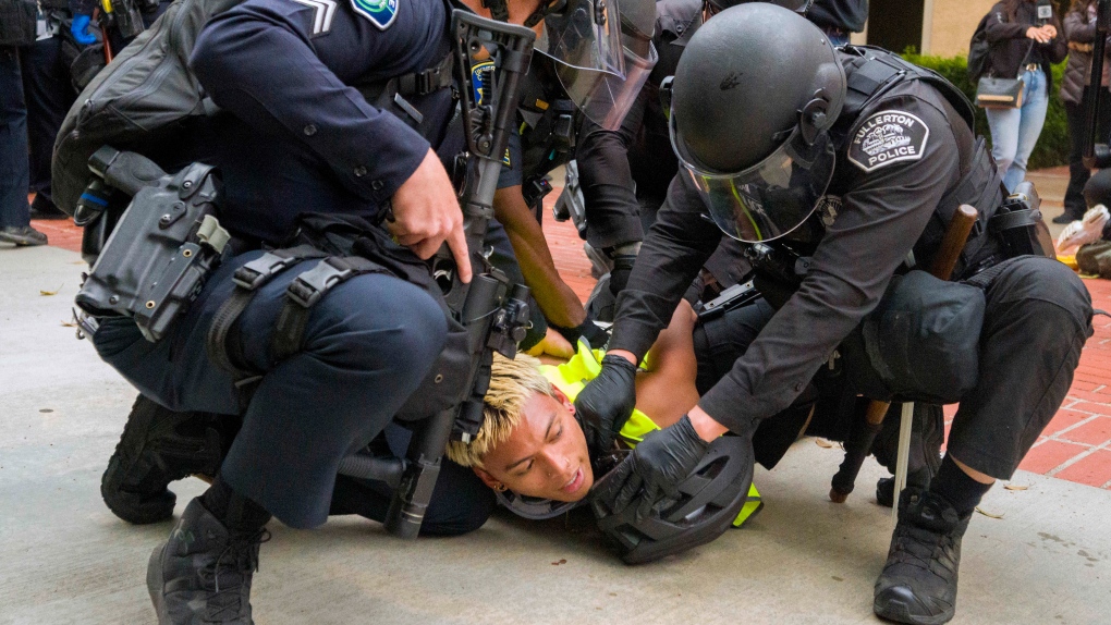 Police wrestle a pro-Palestinian protester