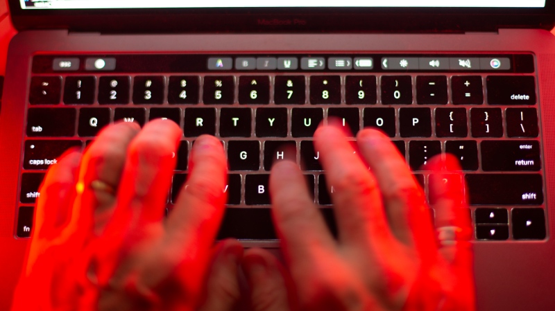 A man uses a computer keyboard. (Graeme Roy/The Canadian Press)