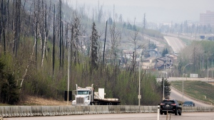 Traffic moves along Highway 63 as wildfire smoke hangs in the air in Fort McMurray, Alta., on Wednesday, May 15, 2024. THE CANADIAN PRESS/Jeff McIntosh