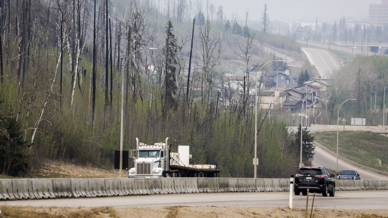 Traffic moves along Highway 63 as wildfire smoke hangs in air in Fort McMurray, Alta., on Wednesday, May 15, 2024. (THE CANADIAN PRESS/Jeff McIntosh)