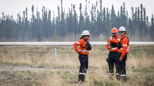 Wildfire specialists with Fire & Flood Emergency Service Ltd., are seen along highway 881 near Gregoire Lake Estates southeast of Fort McMurray, Wednesday, May 15, 2024. (THE CANADIAN PRESS/Jeff McIntosh)