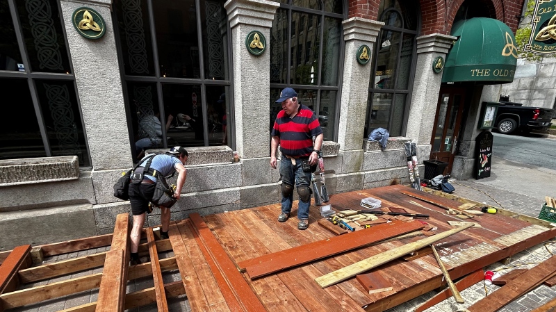 Workers assemble a patio outside The Old Triangle in Halifax. (Jonathan MacInnis/CTV Atlantic)