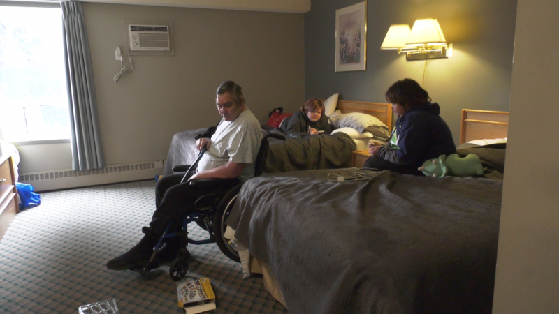 Two of Chelsea Wood's children, and her uncle, who lives with disabilities, in a motel room in Edmonton. (Nav Sangha/CTV News Edmonton)