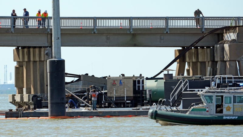 Workers survey the site where a barge crashed into the Pelican Island Bridge, Wednesday, May 15, 2024, in Galveston, Texas. (David J. Phillip / AP Photo)