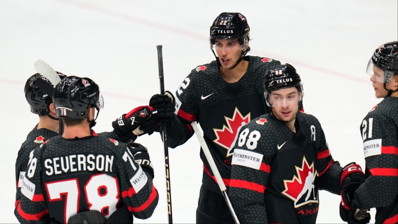 Canada's Dylan Cozens, center, celebrates with teammates after scoring his sides first goal during the preliminary round match between Austria and Canada at the Ice Hockey World Championships in Prague, Czech Republic, Tuesday, May 14, 2024. (AP Photo/Petr David Josek)
