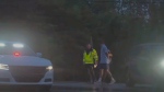 In this still image made from video provided by ESPN, Masters champions Scottie Scheffler is escorted by police after being handcuffed near Valhalla Golf Club, site of the PGA Championship golf tournament, early Friday, May 17, 2024. (ESPN via AP)