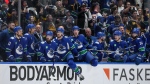 Vancouver Canucks' Brock Boeser, centre, and the rest of the team come off the bench to celebrate after Vancouver defeated the Edmonton Oilers during Game 5 of an NHL hockey Stanley Cup second-round playoff series, in Vancouver, on Thursday, May 16, 2024. THE CANADIAN PRESS/Darryl Dyck