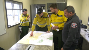 Alberta Wildfire members work in Fort McMurray, where, a few kilometres away, a 20,000-hectare wildfire was burning on May 16, 2024. (Darcy Seaton / CTV News Edmonton) 