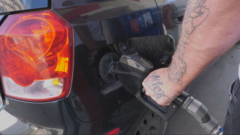 A customer fuels up at a gas station in Quebec.
