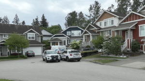 Police respond to the discovery of two dead men at a Surrey, B.C., home on May 15, 2024. 