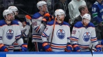 Edmonton Oilers players Cody Ceci, left to right, Corey Perry, Brett Kulak and Connor Brown stand on the bench during the final seconds of the third period in Game 5 of their second-round NHL playoff series against the Vancouver Canucks on May 16, 2024. (Darryl Dyck/The Canadian Press)