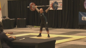 One of the athletes competing holds a barbell over his head for the Canadian Senior Weightlifting Championships. (CTV/Hafsa Arif)