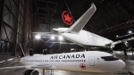 A model airplane is seen in front of the newly revealed Air Canada Boeing 787-8 Dreamliner aircraft at a hangar at the Toronto Pearson International Airport in Mississauga, Ont., Thursday, Feb. 9, 2017. (Mark Blinch, The Canadian Press)