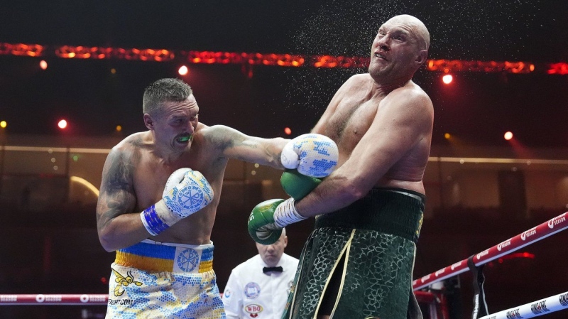 Tyson Fury, right, takes a blow from Oleksandr Usyk during their fight at the Kingdom Arena in Riyadh, Saudi Arabia, Sunday, May 19, 2024. (Nick Potts/PA via AP)
