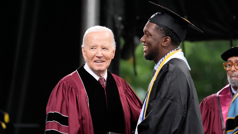 Joe Biden stands with Morehouse valedictorian