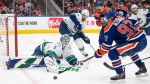 Vancouver Canucks goalie Arturs Silovs makes the save on Edmonton Oilers star Connor McDavid in Game 6 of their second-round NHL playoff series on May 18, 2024, in Edmonton. (Jason Franson/The Canadian Press)