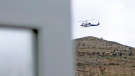 In this photo provided by Islamic Republic News Agency, IRNA, the helicopter carrying Iranian President Ebrahim Raisi takes off at the Iranian border with Azerbaijan after President Raisi and his Azeri counterpart Ilham Aliyev inaugurated the dam of Qiz Qalasi, or Castel of Girl in Azeri, Iran, Sunday, May 19, 2024. (Ali Hamed Haghdoust/IRNA via AP)