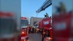 Firefighters in Regina assisting in rescuing someone who became trapped in the bucket of a garbage truck on the morning of May 20, 2024. (Source: Regina Fire)