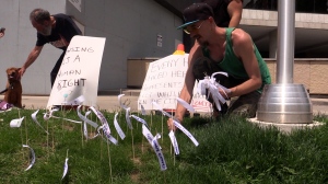Gary ‘Gaz’ Turner places ribbons on the ground outside of London City Hall on Monday May 20, 2024. Each ribbon represents a homeless Londoner who has passed away since 2020 (Source: Brent Lale/CTV London)