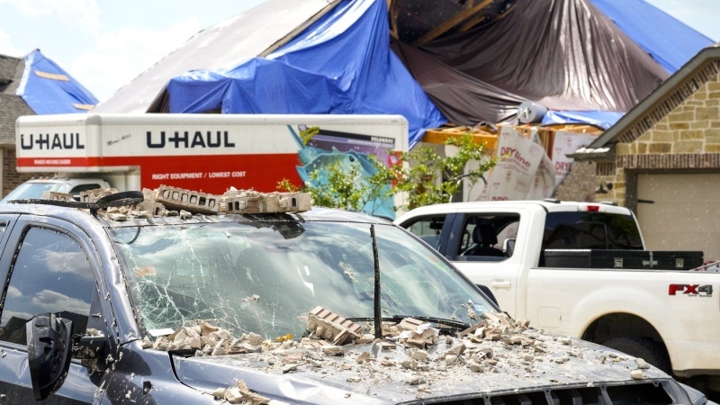 A truck is covered in debris on Sunday, May 19, 2024, in Cypress, Texas. (Brett Coomer/Houston Chronicle)
