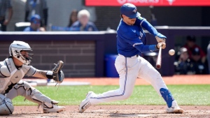 Danny Jansen (9) hits an RBI double during third inning MLB baseball action against the Chicago White Sox, in Toronto, Monday, May 20, 2024. (Chris Young/The Canadian Press)