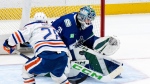 Vancouver Canucks goalie Arturs Silovs stops Edmonton Oilers' Connor Brown during the first period in Game 7 of an NHL hockey Stanley Cup second-round playoff series, in Vancouver, on Monday, May 20, 2024. THE CANADIAN PRESS/Ethan Cairns