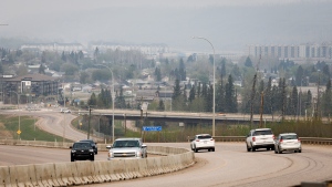Traffic moves along Alberta Highway 63 as wildfire smoke hangs in air in Fort McMurray, Alta., Wednesday, May 15, 2024. THE CANADIAN PRESS/Jeff McIntosh