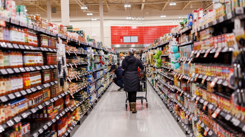 A shopper browses in an aisle at a grocery store in Toronto on Friday, Feb. 2, 2024. THE CANADIAN PRESS/Cole Burston