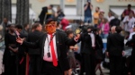 A person dressed as Donald Trump poses for photographers upon arrival at the premiere of the film 'The Apprentice' at the 77th international film festival, Cannes, southern France, Monday, May 20, 2024. (Photo by Andreea Alexandru/Invision/AP)