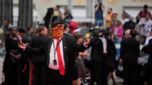 A person dressed as Donald Trump poses for photographers upon arrival at the premiere of the film 'The Apprentice' at the 77th international film festival, Cannes, southern France, Monday, May 20, 2024. (Photo by Andreea Alexandru/Invision/AP)