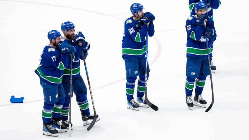 Vancouver Canucks' Filip Hronek, from left to right, Ian Cole, Nils Aman, Ilya Mikheyev, and Sam Lafferty stand on the ice after losing against the Edmonton Oilers in Game 7 of an NHL hockey Stanley Cup second-round playoff series, in Vancouver, on Monday, May 20, 2024. THE CANADIAN PRESS/Ethan Cairns