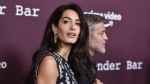 Amal Clooney, left, and George Clooney are seen Oct. 3, 2021, at the Directors Guild of America in Los Angeles. (Photo by Richard Shotwell/Invision/AP, File)