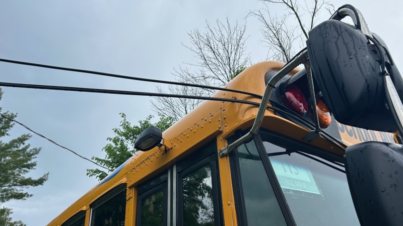 A school bus in Innisfil, Ont., entangled in overhead telephone lines on May 21, 2024. (CTV News/Rob Cooper)