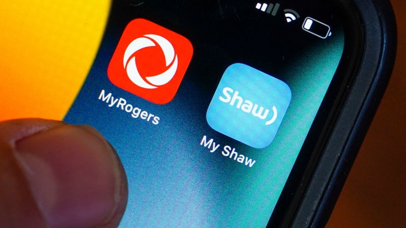 Rogers and Shaw applications are pictured on a cellphone in Ottawa on Monday, May 9, 2022. THE CANADIAN PRESS/Sean Kilpatrick