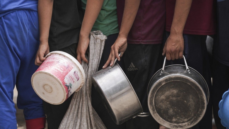 Palestinians line up for food distribution in Deir al Balah, Gaza, Friday, May 10, 2024. (Abdel Kareem Hana/AP Photo)