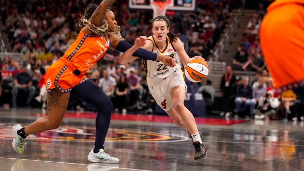 Indiana Fever guard Caitlin Clark, centre, plays during a WNBA basketball game in Indianapolis on Monday, May 20, 2024. (Michael Conroy / AP Photo)