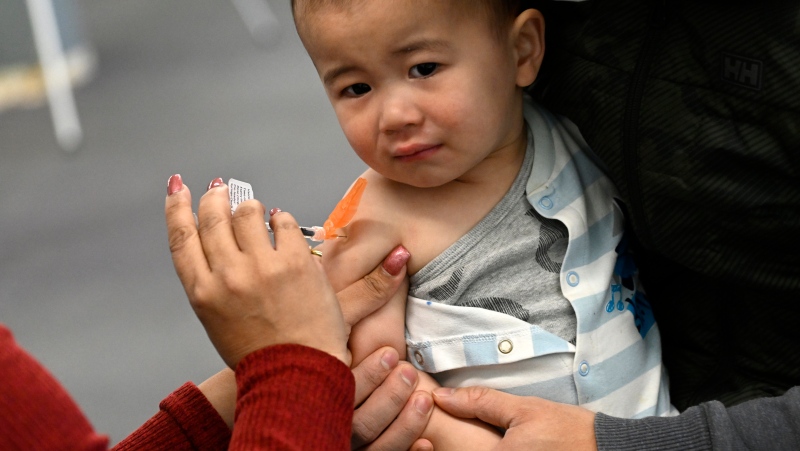 16-month-old Taika Loo receives a vaccine at an Ottawa clinic on Wednesday, November 23, 2022. THE CANADIAN PRESS/Justin Tang