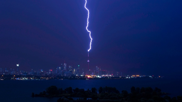 A lightning bolt strikes the CN Tower during an electrical storm in Toronto, early Thursday July 14, 2016. THE CANADIAN PRESS/Mark Blinch
