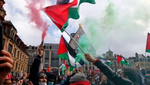 People hold Palestinian flags and flares during a demonstration in Lille, northern France, Saturday May 15, 2021. (Michel Spingler / The Associated Press)