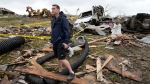 Brian Gutmann, of Creston, Iowa, looks over tornado-damaged property, Tuesday, May 21, 2024, in Greenfield, Iowa. (AP Photo/Charlie Neibergall)
