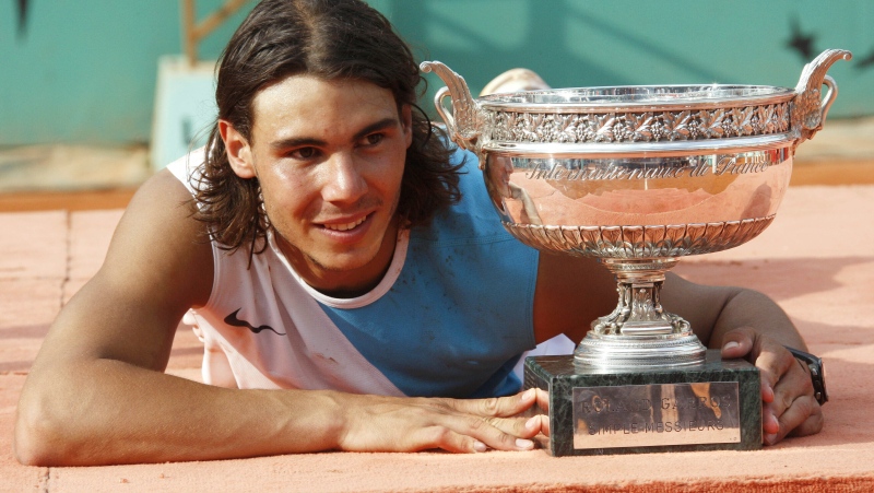 Spain's Rafael Nadal poses with the cup after defeating Switzerland's Roger Federer during the men's final match of the French Open tennis tournament at Roland Garros stadium in Paris, Sunday, June 10, 2007. (AP Photo/Michel Spingler)