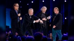 Members of Bachman Turner Overdrive accept their Juno after being inducted into the Canadian Music Hall of Fame during the Juno Awards in Winnipeg, Sunday, March 30, 2014. THE CANADIAN PRESS/John Woods