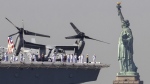 A longstanding U.S. Navy tradition known as Fleet Week sees ships deployed overseas return to port, where crews can disembark and visit the city, while the public gets a chance to tour the vessels. <br><br>
U.S. Sailors and Marines stand on the deck of the USS Bataan as it passes the Statue of Liberty during Fleet Week on Wednesday, May 22, 2024 in New York. (AP Photo/Yuki Iwamura)