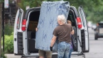 People remove a mattress from a van on moving day in Montreal, Friday, July 1, 2022. THE CANADIAN PRESS/Graham Hughes
