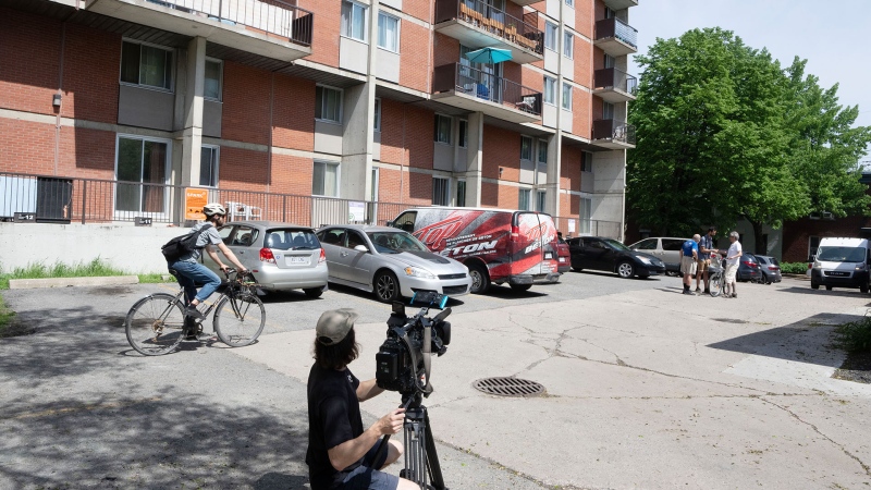 A cameraperson shoots at the scene of a fight that left three people dead, Wednesday, May 22, 2024 in Montreal. Montreal police say three young people, including a 15-year-old boy, have died after a fight broke out in an alley Tuesday night. THE CANADIAN PRESS/Ryan Remiorz
