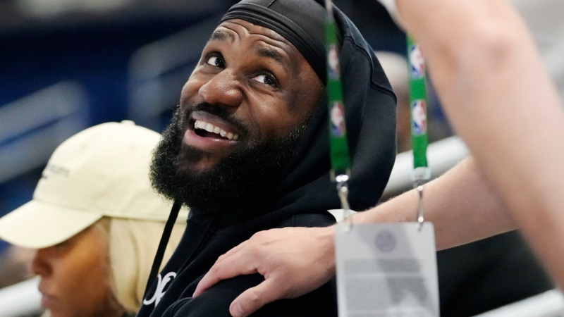 Los Angeles Lakers star LeBron James smiles as he talks with a media member while he watches his son Bronny James during the 2024 NBA Draft Combine 5-on-5 basketball game between Team St. Andrews and Team Love in Chicago, Wednesday, May 15, 2024. (AP Photo/Nam Y. Huh)