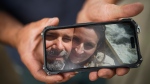 Jason Gaudreault, whose partner Tatjana Stefanski was found dead on April 14 after disappearing a day earlier, shows a photograph of them on his phone, in Lumby, B.C., on Monday, May 13, 2024. THE CANADIAN PRESS/Darryl Dyck